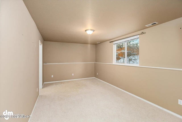 spare room featuring light colored carpet