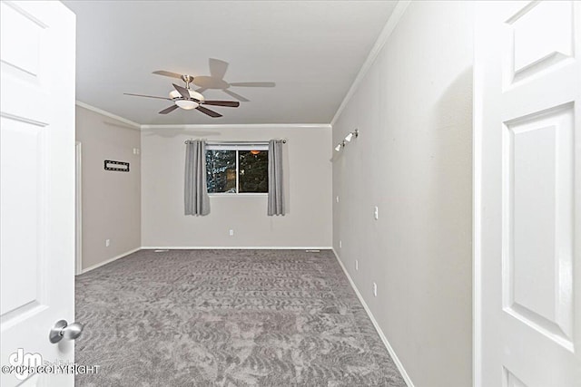 carpeted spare room featuring ceiling fan and crown molding