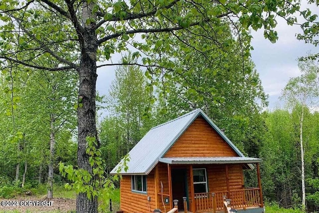 view of outdoor structure featuring covered porch