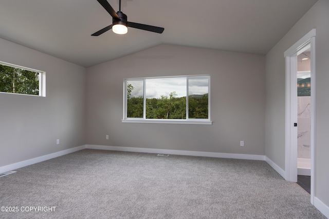 carpeted empty room featuring ceiling fan and vaulted ceiling