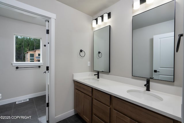 bathroom with tile patterned floors and vanity