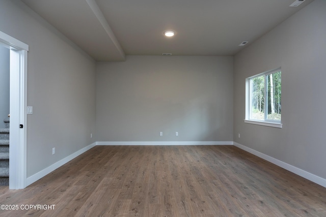 spare room featuring wood-type flooring