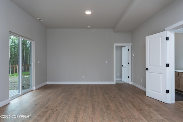 spare room featuring hardwood / wood-style flooring