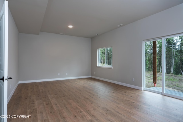 unfurnished room with hardwood / wood-style floors