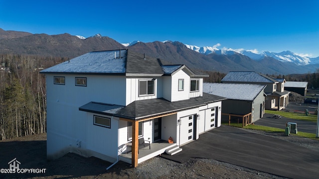 view of front facade featuring a mountain view and a garage