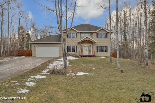 view of front property featuring a front yard and a garage