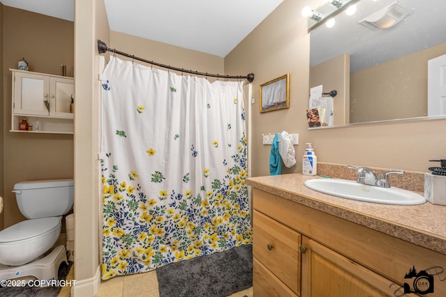 bathroom featuring toilet, vanity, tile patterned floors, and walk in shower