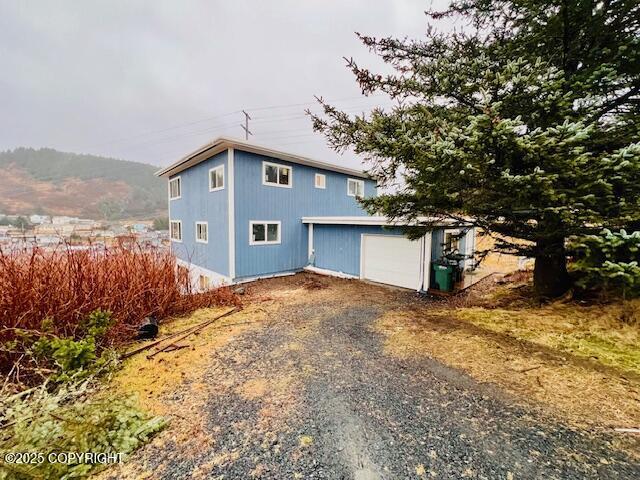 view of side of home with a garage