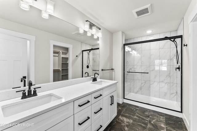 bathroom with vanity and a shower with door