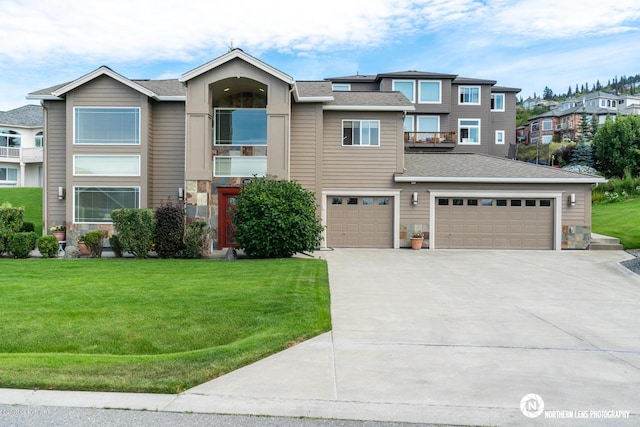 16643 Woods Pointe Cir, Anchorage, AK 99516 - view of front facade featuring concrete driveway, a front yard, and a balcony