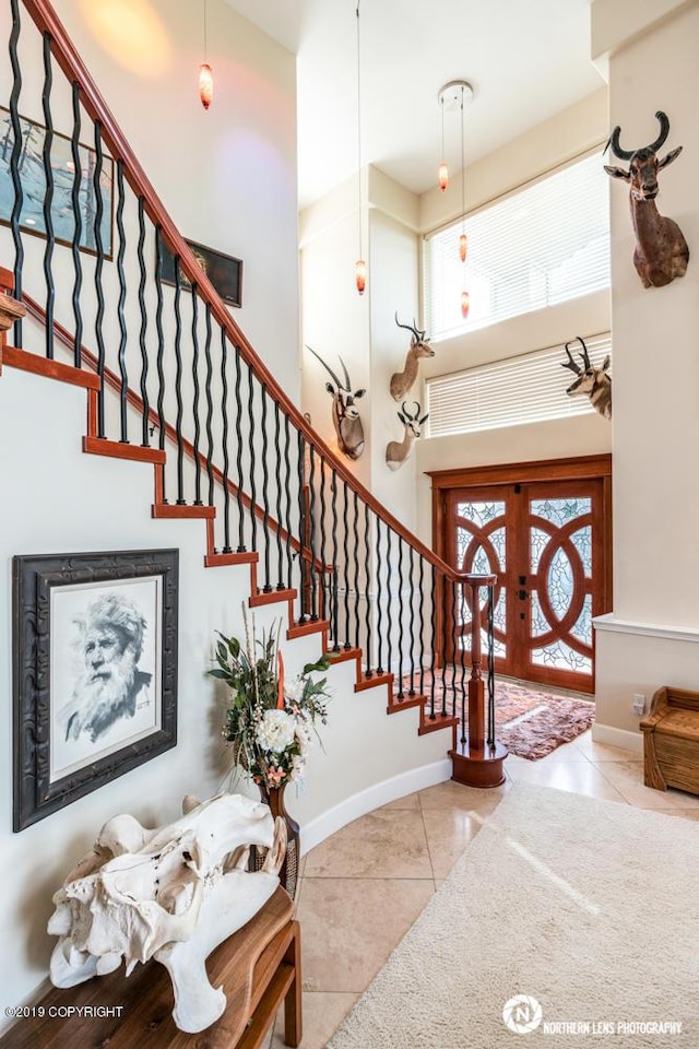 16643 Woods Pointe Cir, Anchorage, AK 99516 - foyer entrance featuring a high ceiling, tile patterned floors, healthy amount of natural light, and stairway