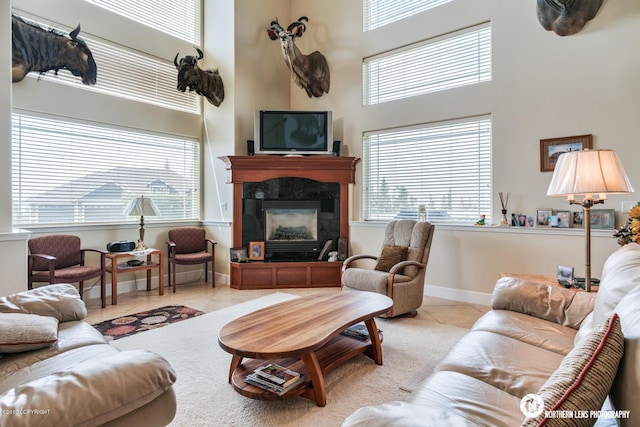 16643 Woods Pointe Cir, Anchorage, AK 99516 - living room featuring a towering ceiling, tile patterned floors, and a tiled fireplace