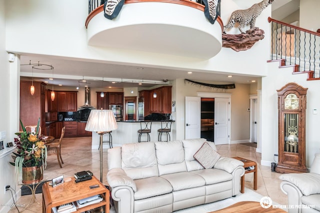 16643 Woods Pointe Cir, Anchorage, AK 99516 - living room with light tile patterned floors, a high ceiling, recessed lighting, and stairway