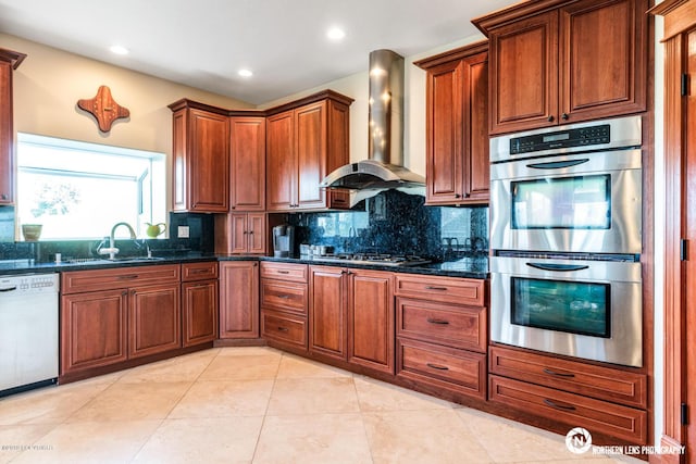 16643 Woods Pointe Cir, Anchorage, AK 99516 - kitchen featuring appliances with stainless steel finishes, wall chimney range hood, decorative backsplash, recessed lighting, and light tile patterned floors