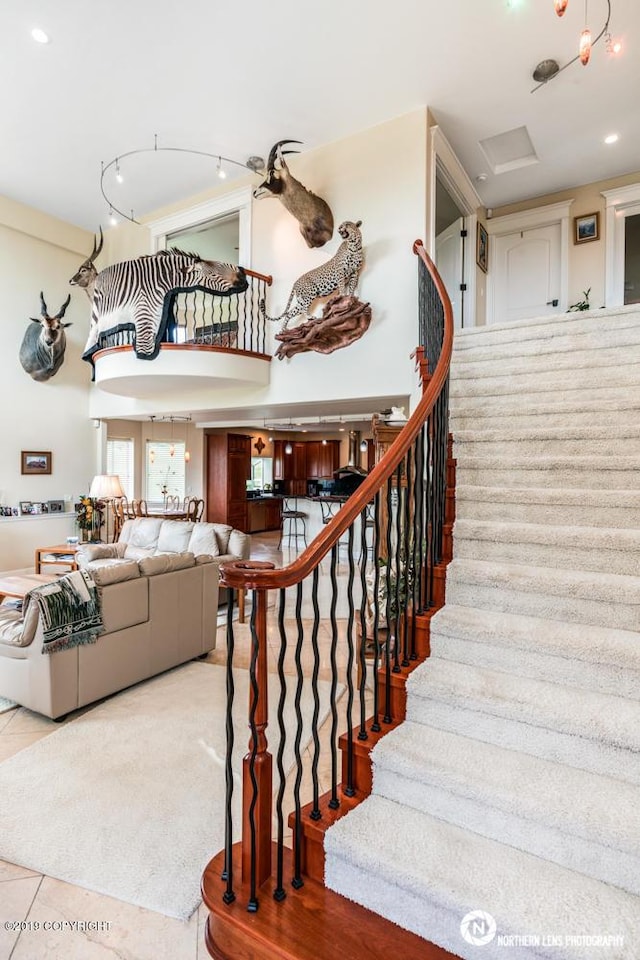 16643 Woods Pointe Cir, Anchorage, AK 99516 - stairs featuring tile patterned floors and a towering ceiling