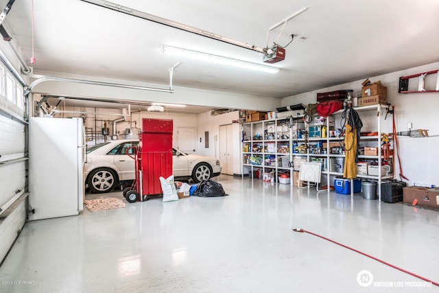 16643 Woods Pointe Cir, Anchorage, AK 99516 - garage with freestanding refrigerator and a garage door opener