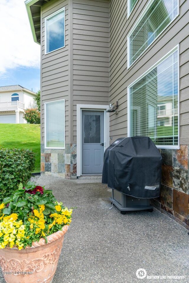 16643 Woods Pointe Cir, Anchorage, AK 99516 - doorway to property with stone siding