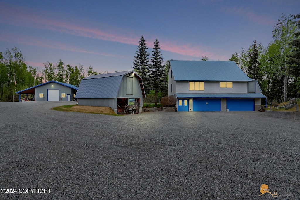 view of front of home with a garage and an outdoor structure