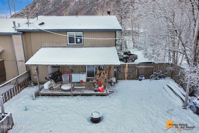 snow covered property with a deck