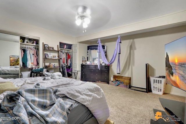 carpeted bedroom with two closets and ceiling fan