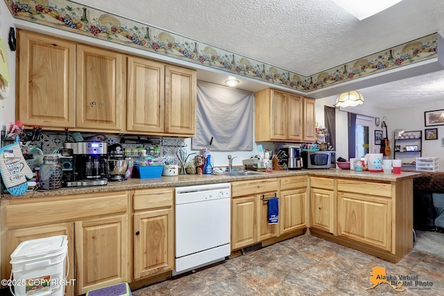 kitchen with kitchen peninsula, dishwasher, a textured ceiling, and sink