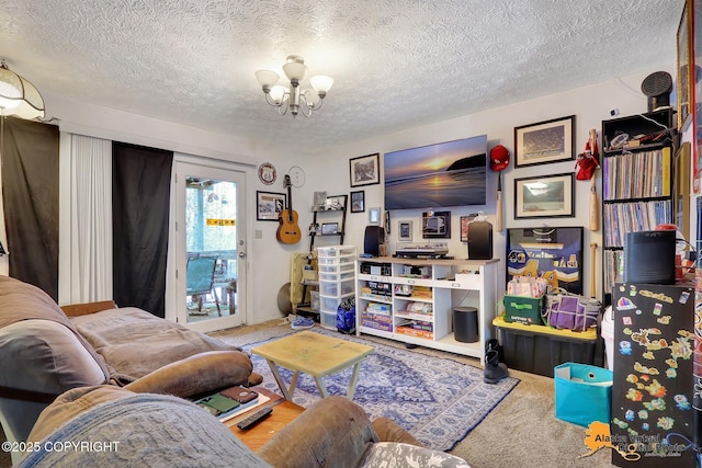 living room featuring carpet floors, a textured ceiling, and an inviting chandelier