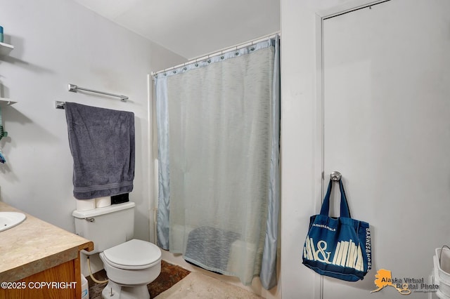 bathroom with vanity, toilet, and curtained shower