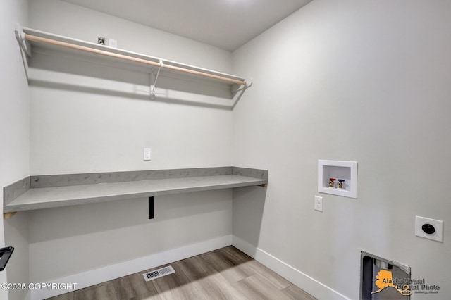8803 Chalk Hill Loop, Anchorage, AK 99502 - laundry room featuring electric dryer hookup, wood finished floors, hookup for a washing machine, and an office area