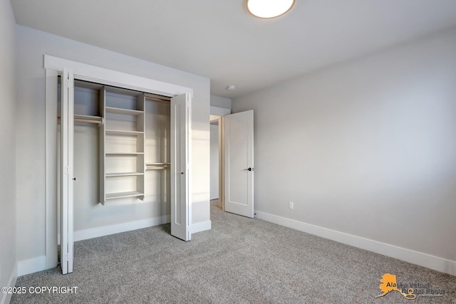 8803 Chalk Hill Loop, Anchorage, AK 99502 - unfurnished bedroom with carpet and a closet