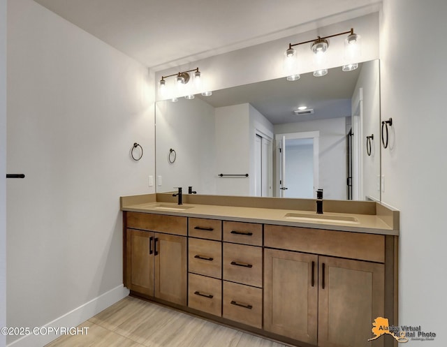 8803 Chalk Hill Loop, Anchorage, AK 99502 - bathroom featuring double vanity and baseboards