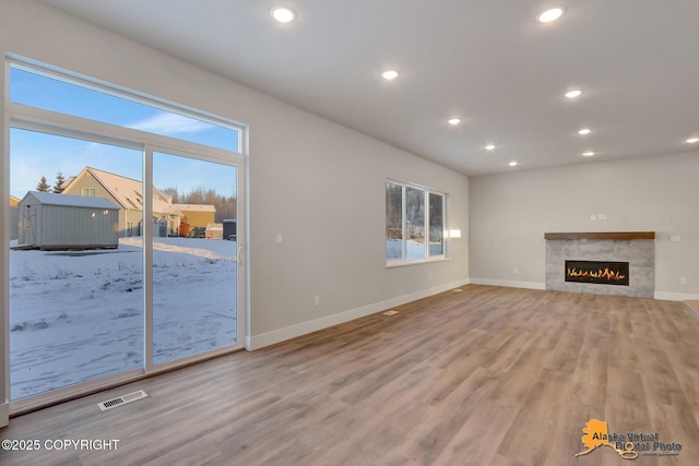 8803 Chalk Hill Loop, Anchorage, AK 99502 - unfurnished living room featuring wood finished floors, recessed lighting, and a fireplace