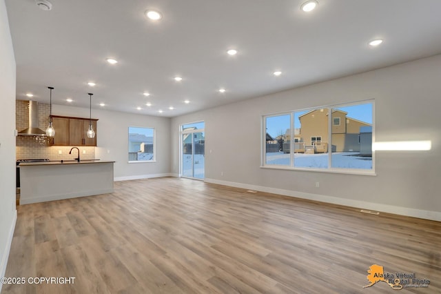 8803 Chalk Hill Loop, Anchorage, AK 99502 - unfurnished living room with recessed lighting and light wood-type flooring