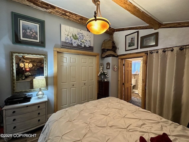 bedroom with a closet and beamed ceiling