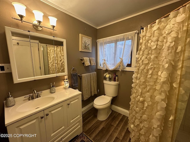 bathroom with toilet, crown molding, hardwood / wood-style flooring, and vanity