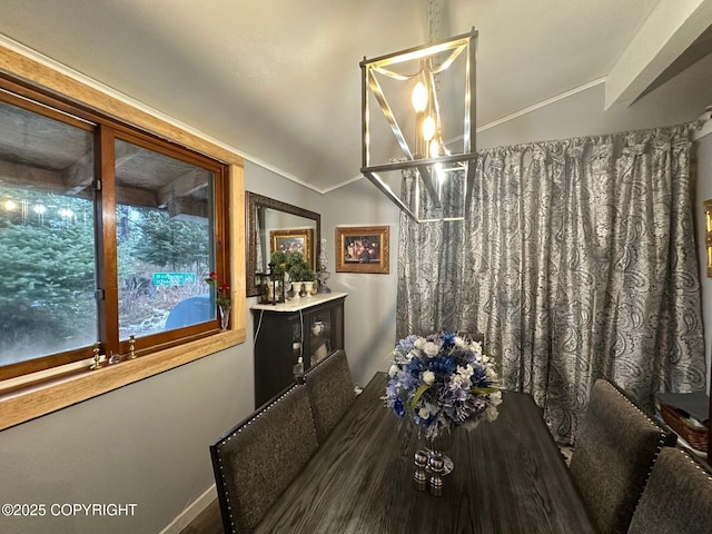 dining room with hardwood / wood-style floors and vaulted ceiling