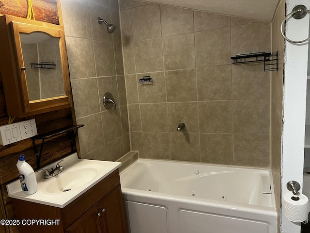 bathroom with vanity, vaulted ceiling, and tiled shower / bath