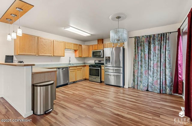 kitchen with light hardwood / wood-style flooring, a chandelier, decorative light fixtures, light brown cabinetry, and appliances with stainless steel finishes