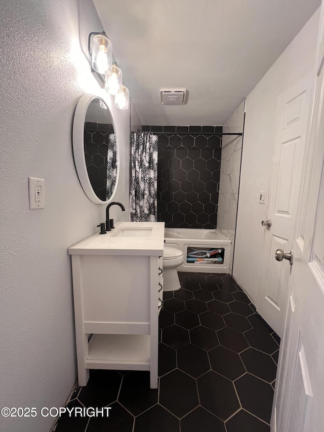 full bathroom with toilet, tile patterned floors, shower / tub combo with curtain, and vanity