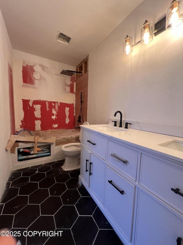 full bathroom with toilet, shower / washtub combination, vanity, and tile patterned floors