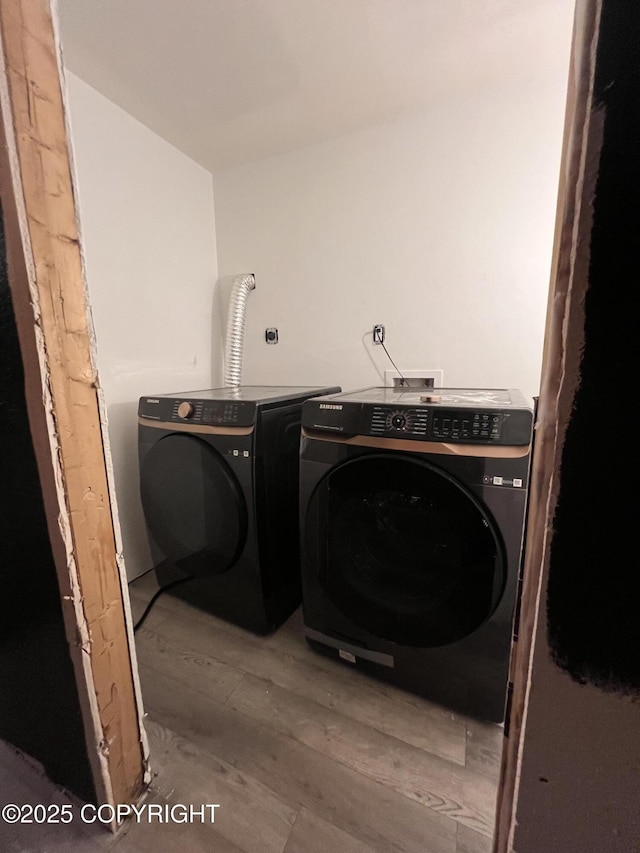 washroom with light wood-type flooring and washer and clothes dryer