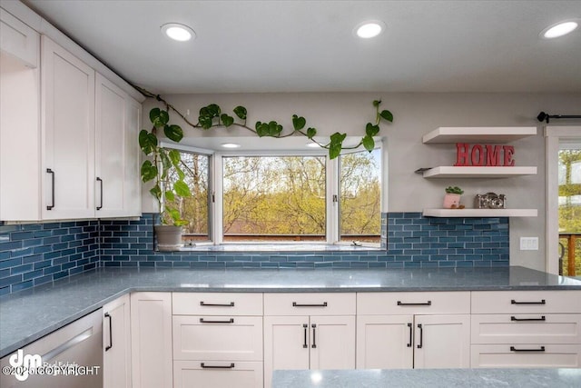 kitchen featuring white cabinets, dishwasher, and tasteful backsplash