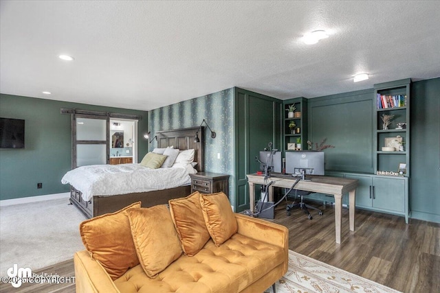 bedroom with dark hardwood / wood-style flooring and a textured ceiling