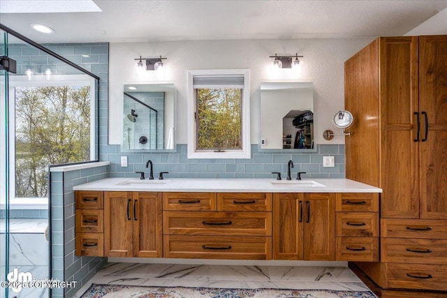 bathroom with tasteful backsplash, vanity, and an enclosed shower