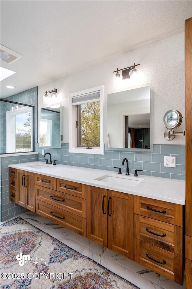 bathroom with decorative backsplash, a shower with door, and vanity