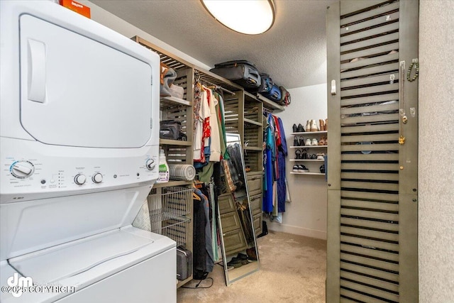 clothes washing area featuring light carpet, stacked washing maching and dryer, and a textured ceiling