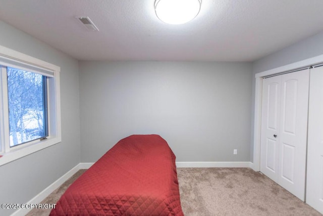 carpeted bedroom featuring a closet