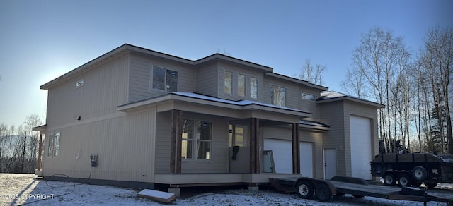 view of front of home with a garage and a porch