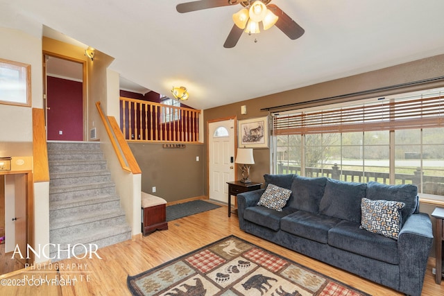 living room featuring hardwood / wood-style floors, vaulted ceiling, and ceiling fan