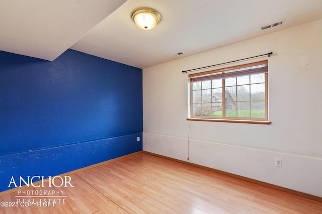 empty room with hardwood / wood-style floors