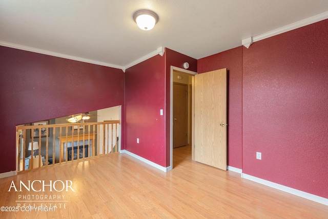 interior space with wood-type flooring and crown molding